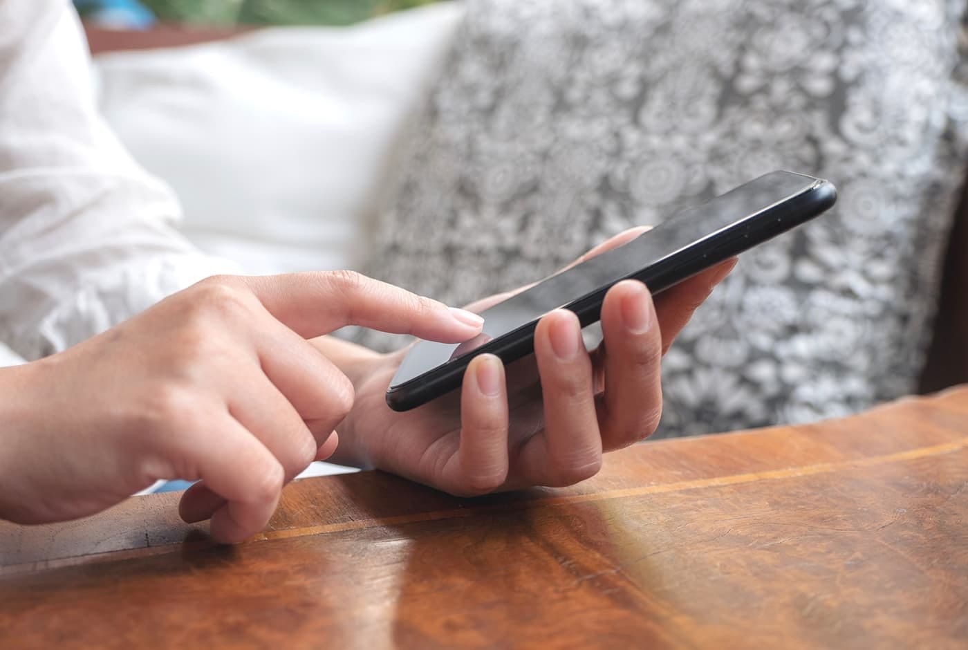 a hand holding a smartphone